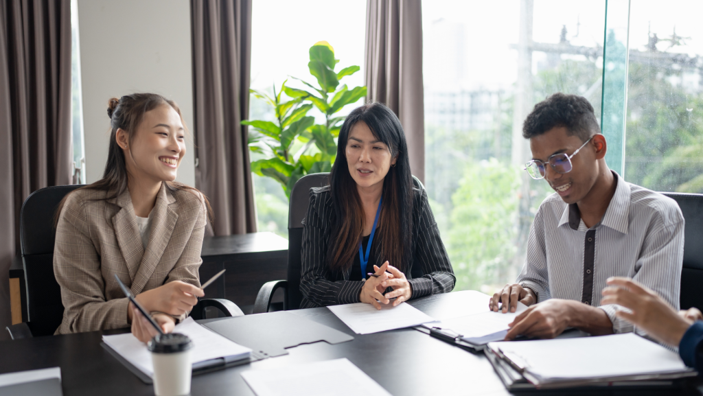 A group of professional real estate agents or business people having a serious discussion over documents in a modern office.