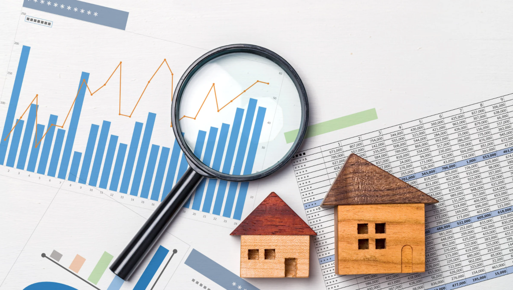 Real estate market analysis concept with charts, graphs, and wooden house models symbolizing Bay Area property trends.
